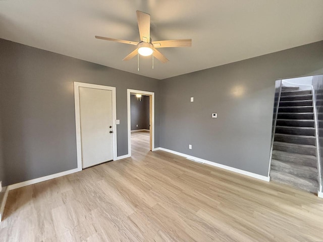 spare room with ceiling fan and light wood-type flooring