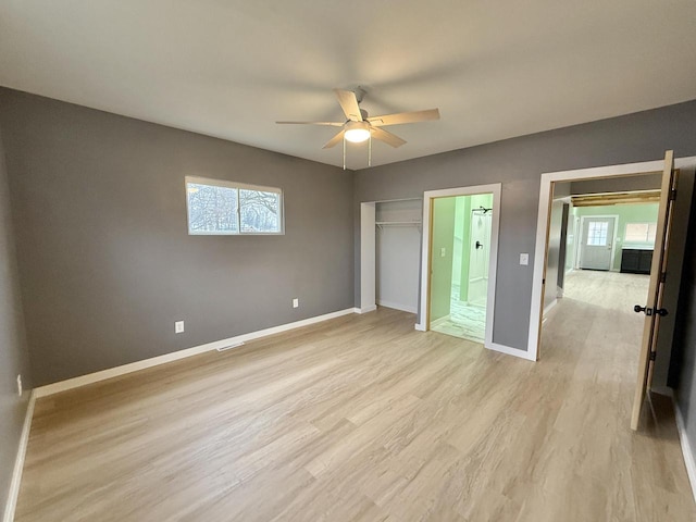 unfurnished bedroom featuring a closet, ceiling fan, ensuite bathroom, and light hardwood / wood-style floors