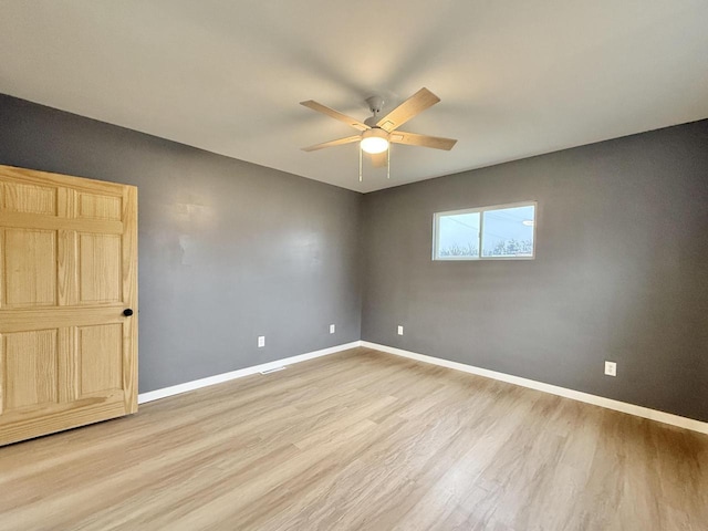 spare room featuring ceiling fan and light wood-type flooring