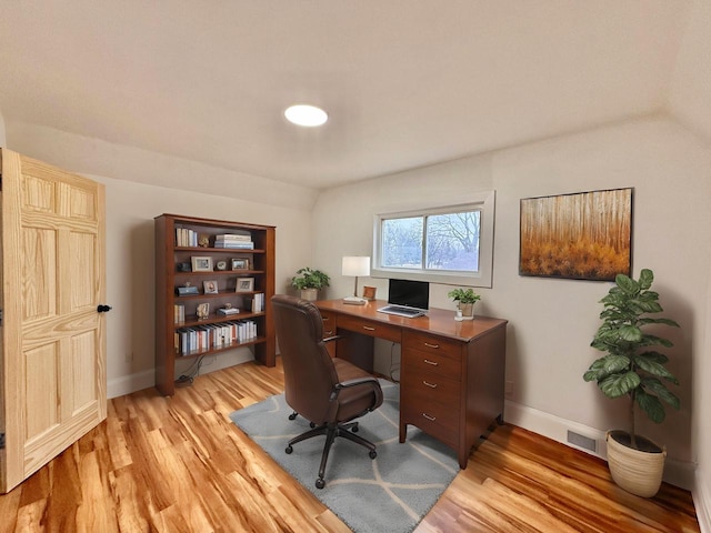 office space with lofted ceiling and light hardwood / wood-style flooring