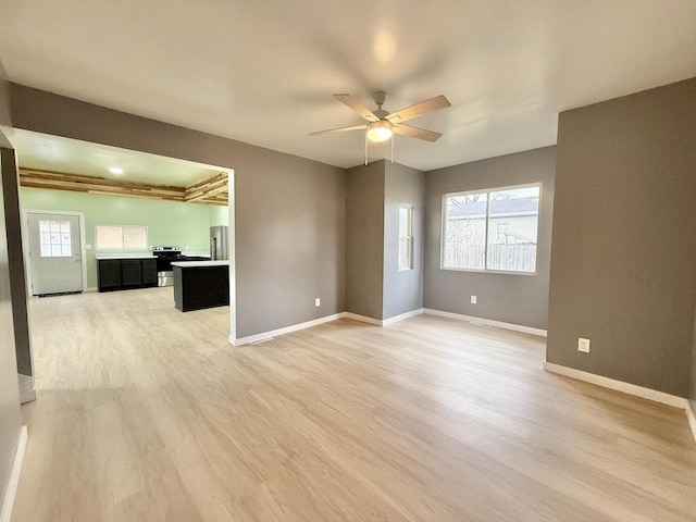 empty room featuring hardwood / wood-style flooring and ceiling fan