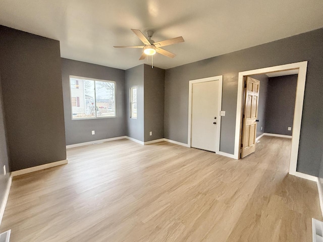 empty room with light hardwood / wood-style flooring and ceiling fan