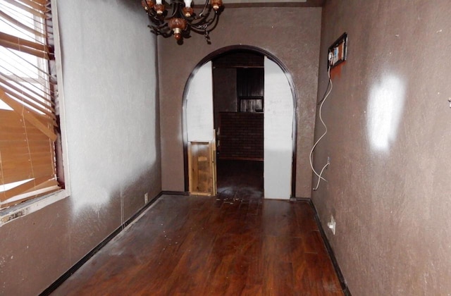 interior space featuring dark hardwood / wood-style floors and an inviting chandelier