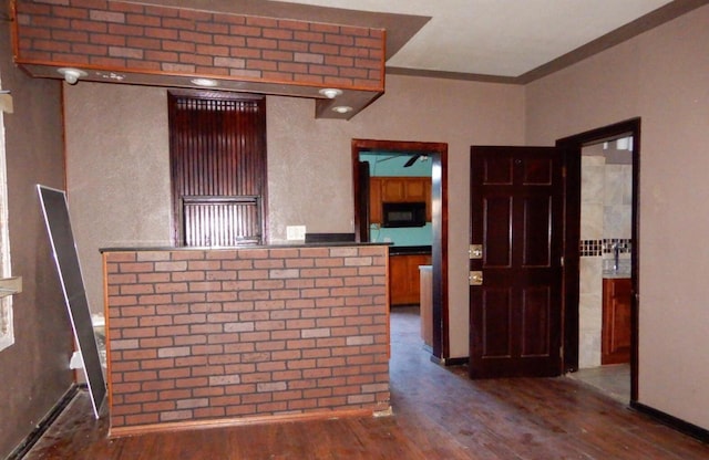 interior space featuring dark hardwood / wood-style floors and crown molding