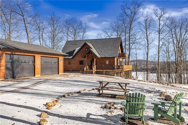 log-style house with a garage