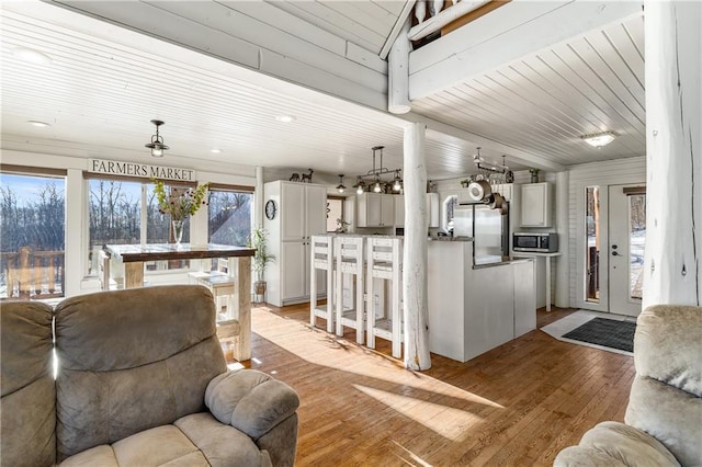 living room featuring light hardwood / wood-style flooring and wooden ceiling