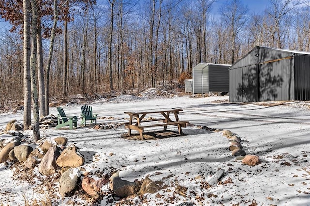 snowy yard with an outbuilding