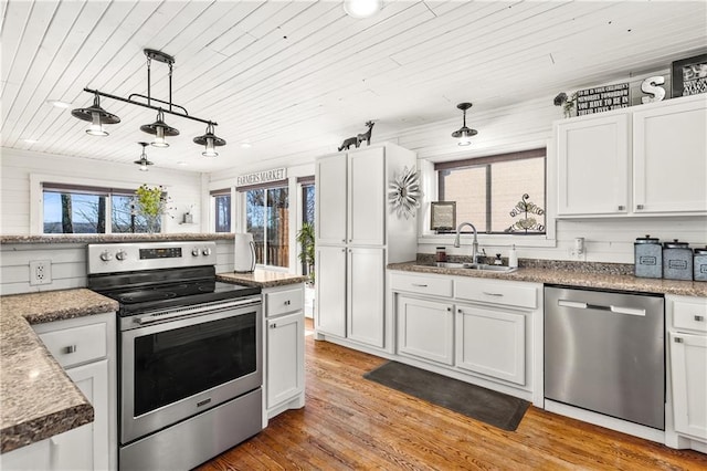 kitchen featuring appliances with stainless steel finishes, white cabinetry, and wooden ceiling