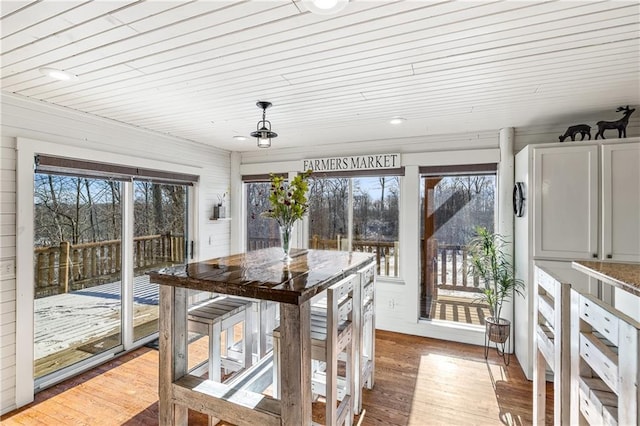 sunroom / solarium featuring wood ceiling