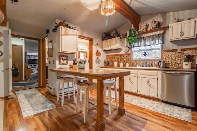 kitchen with decorative backsplash, dishwasher, light hardwood / wood-style floors, and sink