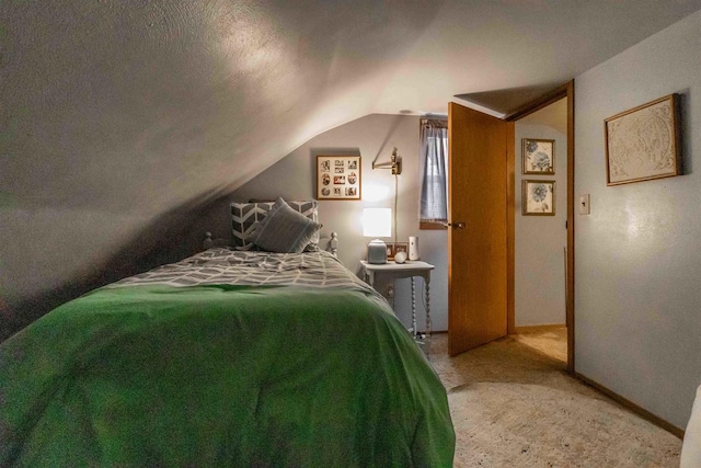 carpeted bedroom featuring vaulted ceiling