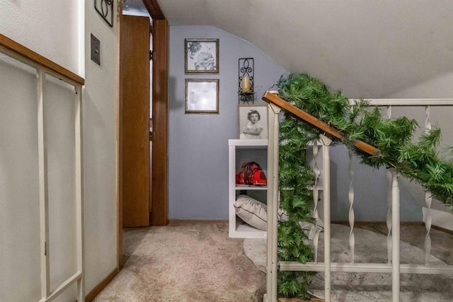 interior space featuring carpet flooring and vaulted ceiling