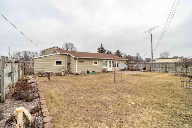 back of property featuring a patio area and a yard