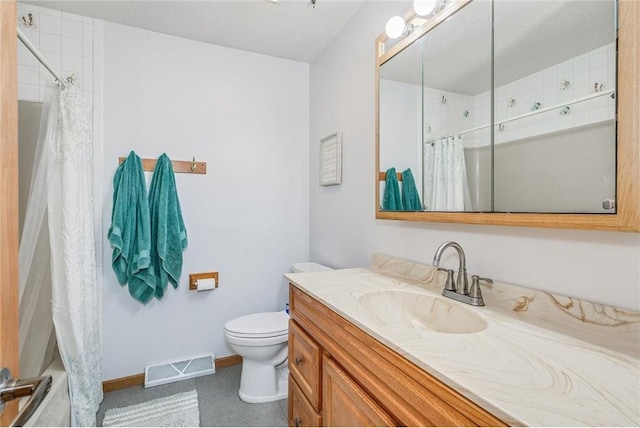 bathroom featuring tile patterned flooring, vanity, and toilet