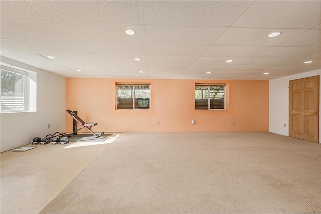 workout area featuring carpet floors and a drop ceiling