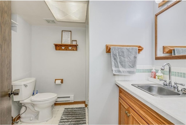 bathroom featuring baseboard heating, vanity, and toilet