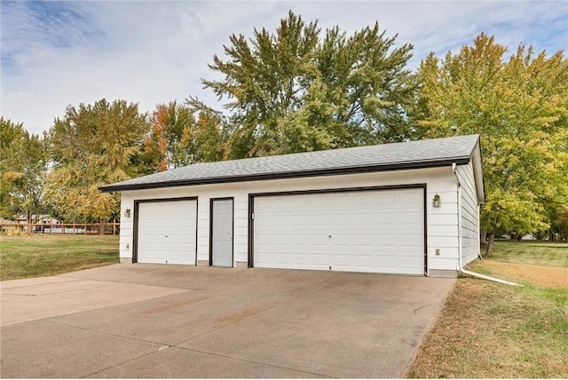 garage featuring a lawn