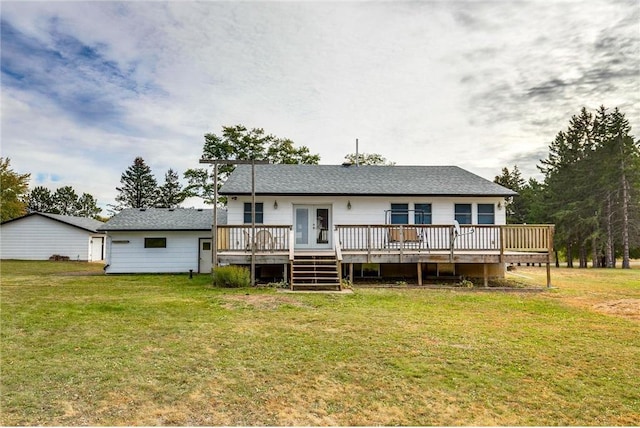 rear view of house with a deck and a yard