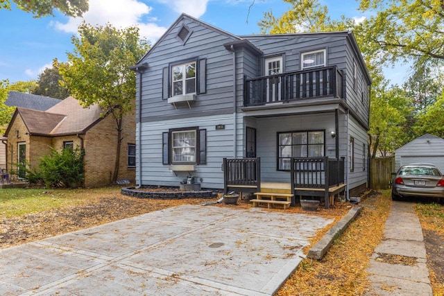 view of front of home with a balcony, a garage, and an outdoor structure