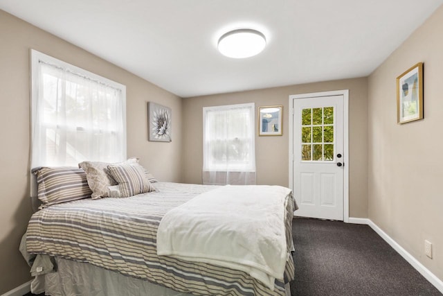 bedroom with dark colored carpet