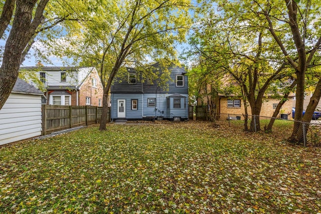 back of house featuring a yard