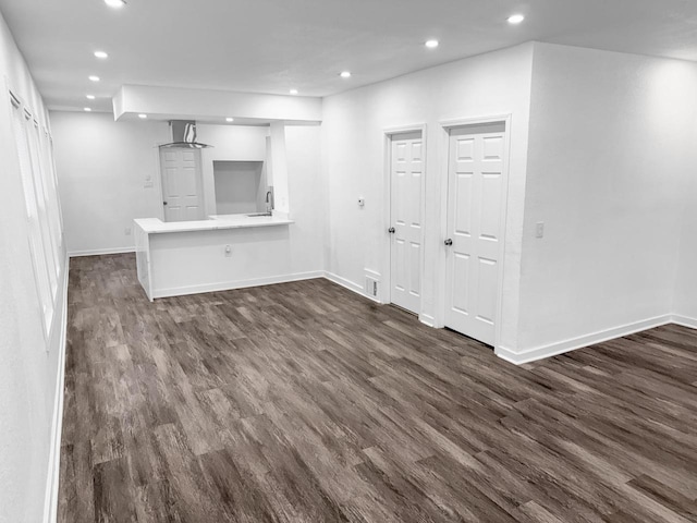 interior space with dark hardwood / wood-style flooring and sink