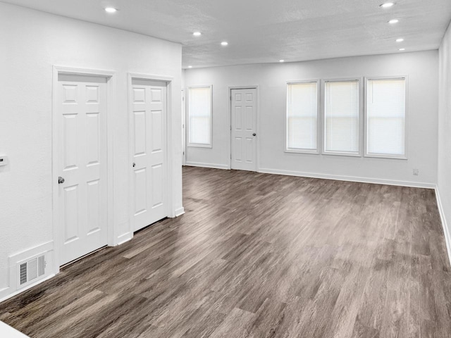 unfurnished room with dark hardwood / wood-style flooring