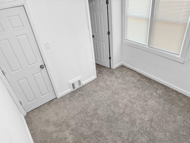 unfurnished bedroom featuring light colored carpet