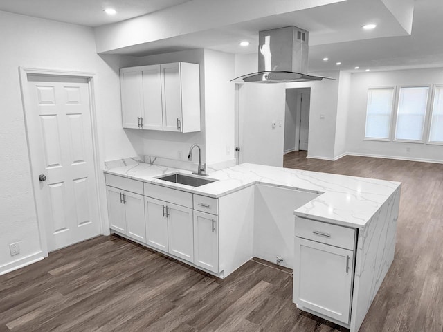 kitchen featuring white cabinetry, sink, light stone countertops, and island range hood