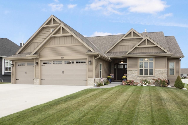 craftsman house with a garage and a front lawn