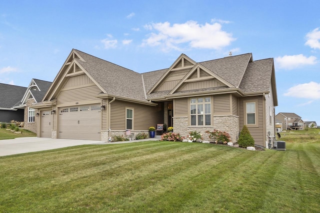 craftsman house featuring a front yard, a garage, and central AC unit