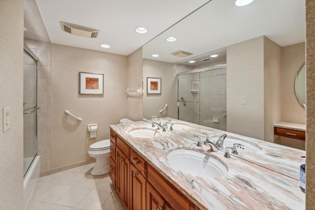 full bathroom with tile patterned flooring, vanity, toilet, and bath / shower combo with glass door