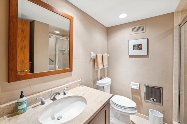 bathroom with vanity, toilet, walk in shower, and heating unit