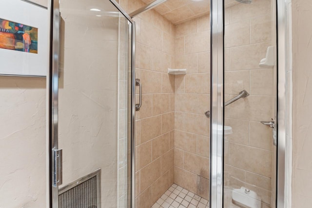 bathroom with a shower with shower door