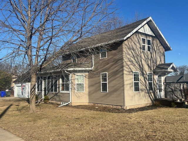 view of side of home with a garage and a lawn