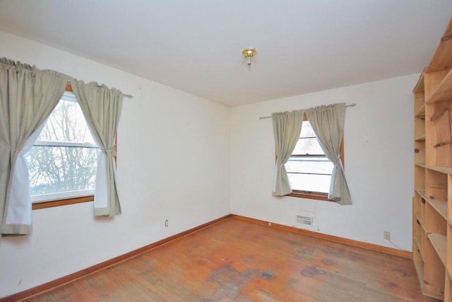 spare room with hardwood / wood-style floors