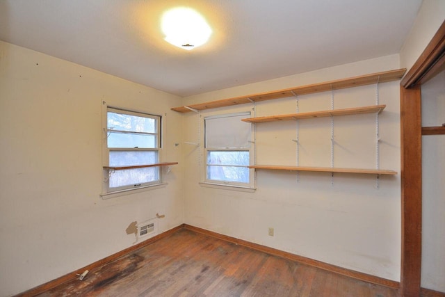 unfurnished room featuring dark wood-type flooring