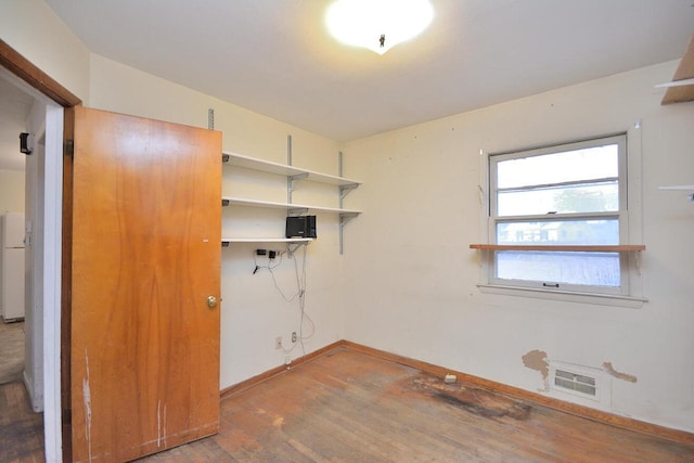 laundry area with wood-type flooring