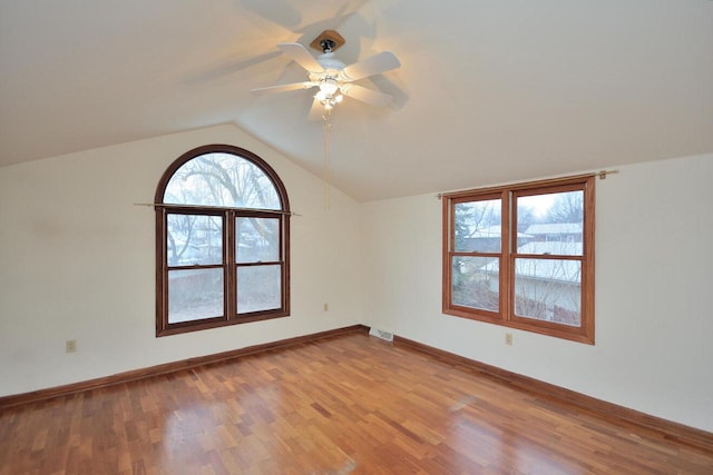 additional living space with plenty of natural light, vaulted ceiling, and light hardwood / wood-style flooring