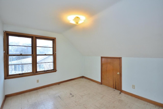 additional living space featuring vaulted ceiling