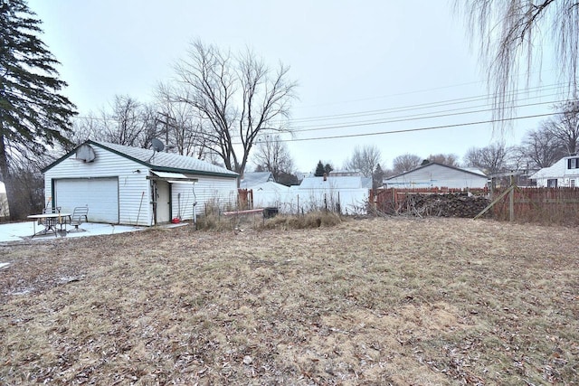 view of yard featuring a patio, an outdoor structure, and a garage