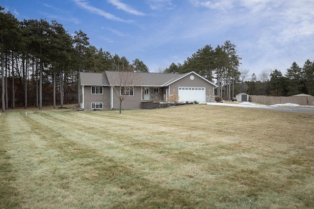 view of front of home with a front yard and a garage