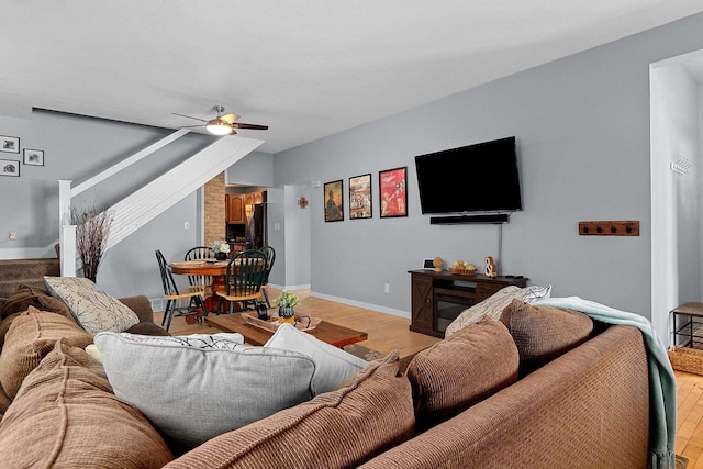 living room featuring ceiling fan and light hardwood / wood-style floors