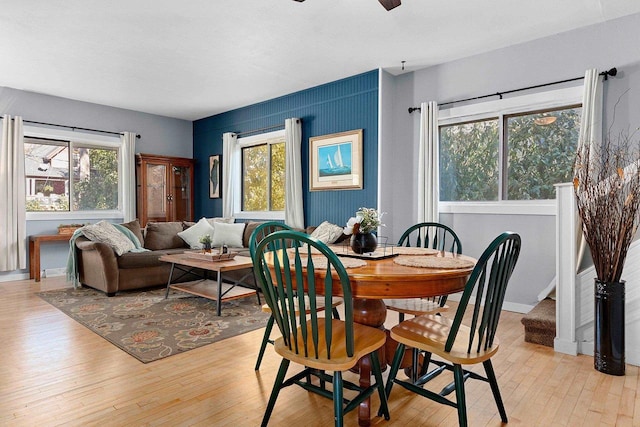 dining room with light hardwood / wood-style floors and ceiling fan