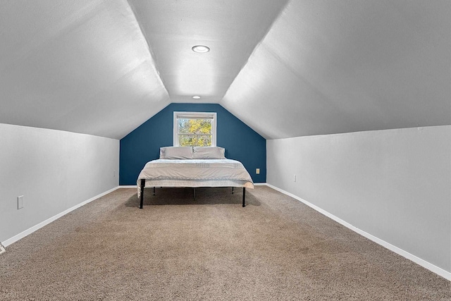 bedroom featuring carpet floors and vaulted ceiling