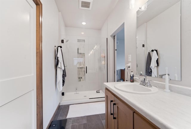 bathroom featuring tile patterned floors, vanity, and an enclosed shower