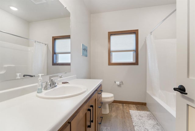 full bathroom featuring vanity, wood-type flooring, shower / tub combo, and toilet