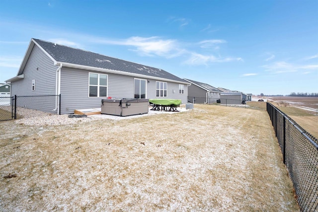 back of house featuring a hot tub