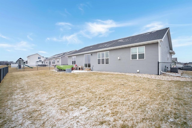 back of property with a lawn and central air condition unit