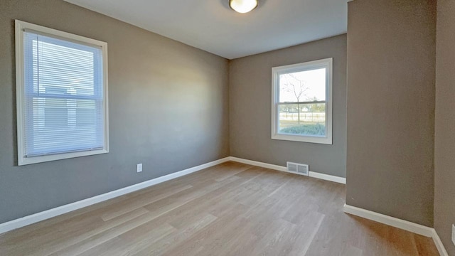 unfurnished room with light hardwood / wood-style floors